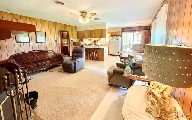 5815 Robin Ln, Troy, MO 63379 - living room featuring wooden walls, ceiling fan, and light colored carpet