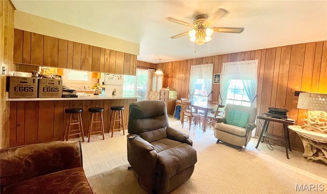 5815 Robin Ln, Troy, MO 63379 - living area with a ceiling fan, wooden walls, and light colored carpet