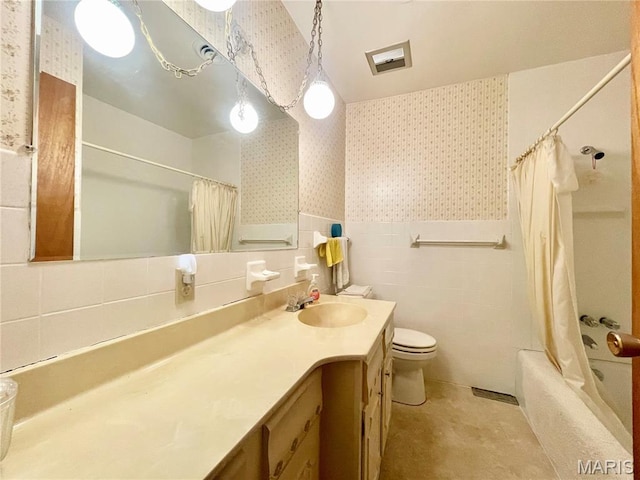 5815 Robin Ln, Troy, MO 63379 - full bathroom with wallpapered walls, vanity, shower / tub combo, wainscoting, and tile walls