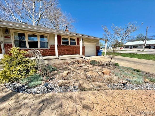 1101 S Mildred Blvd, Salem, MO 65560 - ranch-style home featuring brick siding, an attached garage, covered porch, and driveway