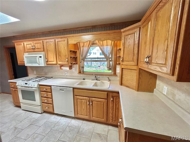 1101 S Mildred Blvd, Salem, MO 65560 - kitchen featuring white appliances, a sink, light countertops, decorative backsplash, and a skylight