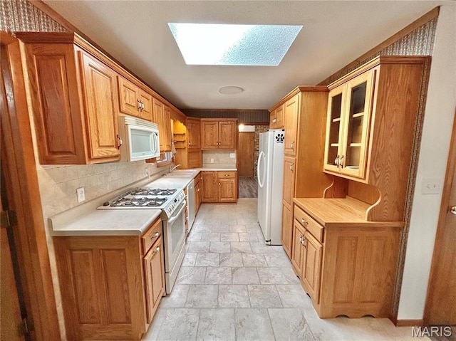 1101 S Mildred Blvd, Salem, MO 65560 - kitchen with white appliances, stone tile flooring, light countertops, and decorative backsplash