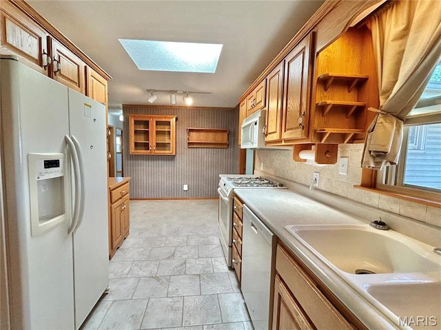 1101 S Mildred Blvd, Salem, MO 65560 - kitchen with white appliances, a skylight, open shelves, a sink, and light stone finish floors
