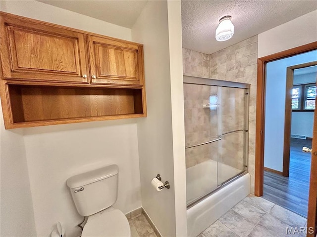 1101 S Mildred Blvd, Salem, MO 65560 - bathroom featuring baseboards, enclosed tub / shower combo, toilet, and a textured ceiling