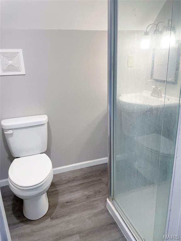 109 N Oak St, Rolla, MO 65401 - full bath with wood finished floors, baseboards, toilet, and a shower stall