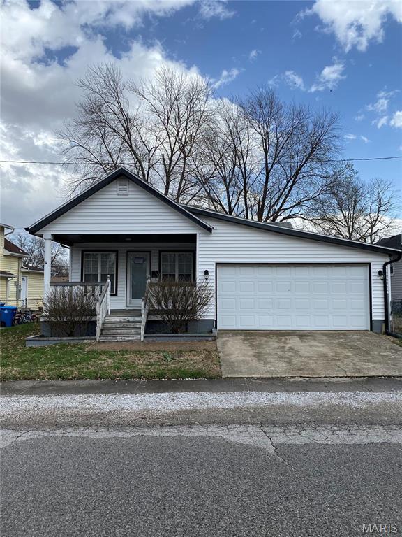 2938 Oregon Ave, Granite City, IL 62040 - view of front facade with a porch, concrete driveway, and a garage