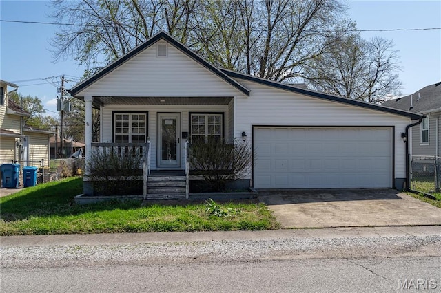 2938 Oregon Ave, Granite City, IL 62040 - view of front of home with covered porch, an attached garage, and concrete driveway