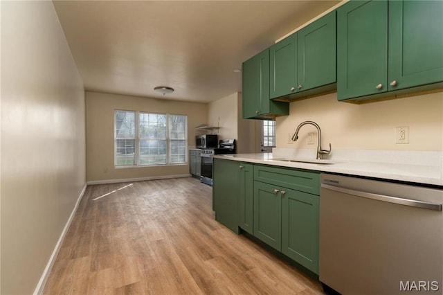 2938 Oregon Ave, Granite City, IL 62040 - kitchen with stainless steel appliances, green cabinets, light countertops, and light wood-style floors