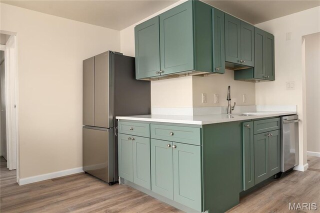 2938 Oregon Ave, Granite City, IL 62040 - kitchen featuring freestanding refrigerator, green cabinets, light wood-type flooring, and light countertops