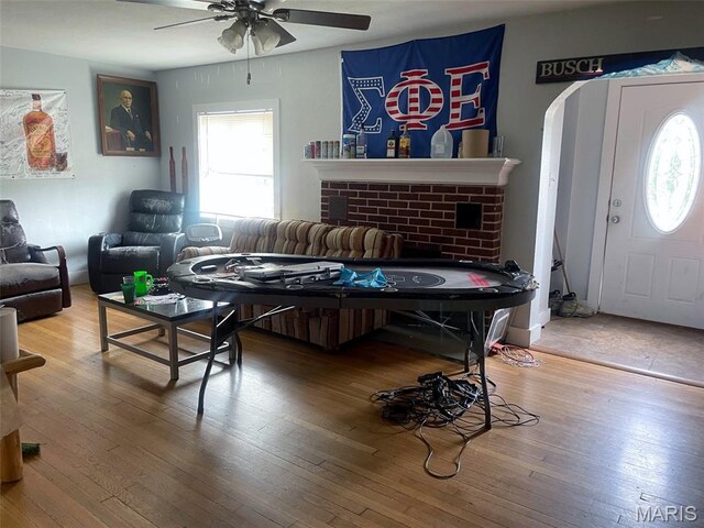 709 E 10th St, Rolla, MO 65401 - living room with ceiling fan, plenty of natural light, hardwood / wood-style flooring, and a brick fireplace