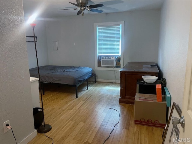 709 E 10th St, Rolla, MO 65401 - bedroom with light wood-style floors, cooling unit, and baseboards