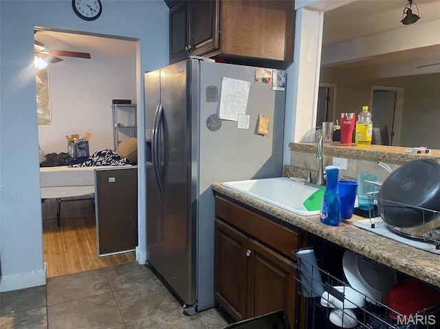 709 E 10th St, Rolla, MO 65401 - kitchen with stainless steel fridge with ice dispenser, a sink, ceiling fan, and light countertops