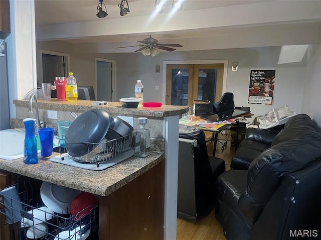 709 E 10th St, Rolla, MO 65401 - kitchen featuring light wood finished floors, french doors, a ceiling fan, a sink, and open floor plan
