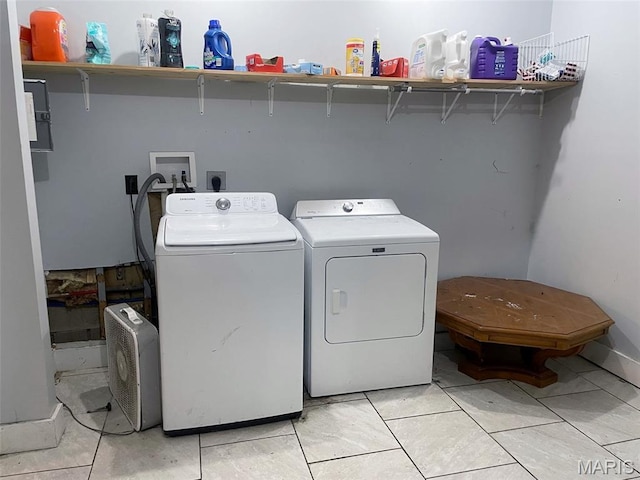 709 E 10th St, Rolla, MO 65401 - washroom with washing machine and dryer and light tile patterned floors