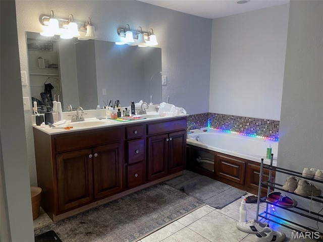 709 E 10th St, Rolla, MO 65401 - full bathroom with double vanity, a textured wall, tile patterned flooring, and a garden tub