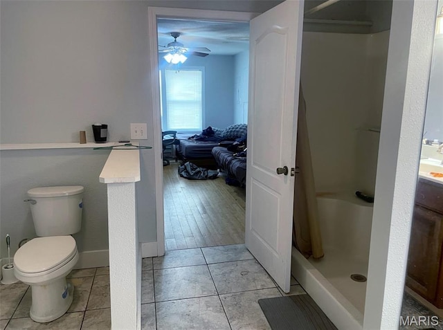 709 E 10th St, Rolla, MO 65401 - full bath with a shower stall, toilet, ceiling fan, and tile patterned floors