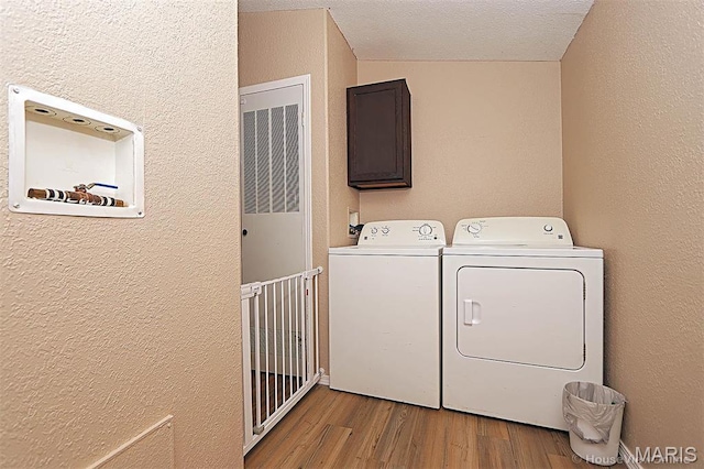 301 Kimberly Dr, Scott City, MO 63780 - laundry room with washer and dryer, a textured wall, and wood finished floors
