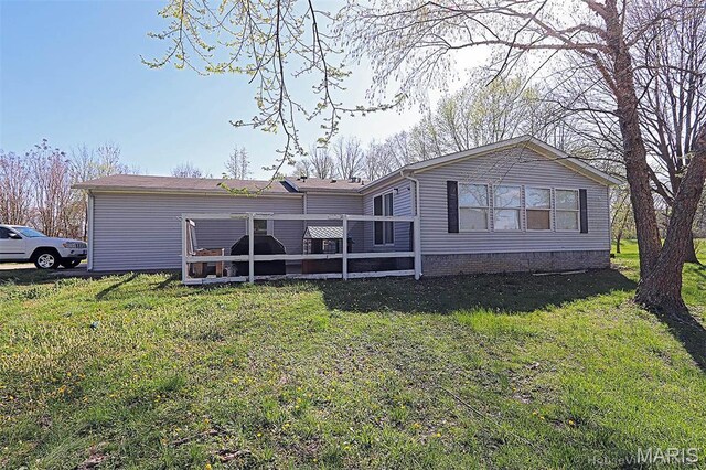 301 Kimberly Dr, Scott City, MO 63780 - rear view of property featuring a deck and a lawn
