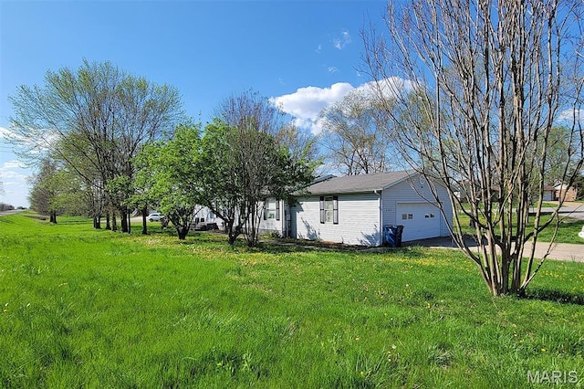 301 Kimberly Dr, Scott City, MO 63780 - view of green lawn with a garage and asphalt driveway