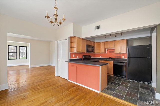 6026 Waterman Blvd Unit 1W, Saint Louis, MO 63112 - kitchen featuring black appliances, open shelves, dark countertops, a chandelier, and a peninsula
