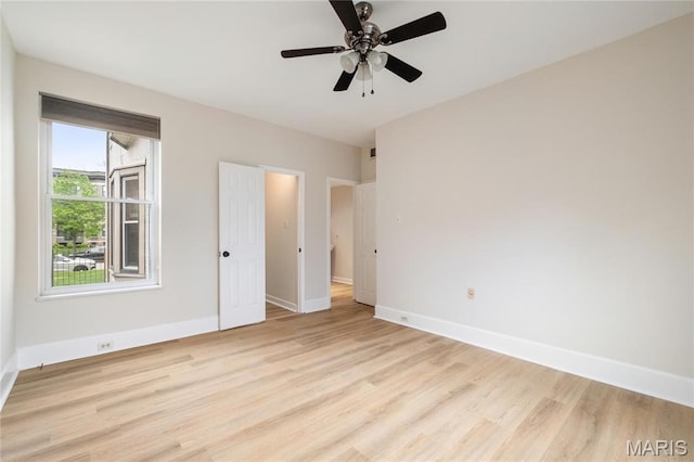 6026 Waterman Blvd Unit 1W, Saint Louis, MO 63112 - unfurnished bedroom featuring baseboards, light wood-style flooring, and a ceiling fan