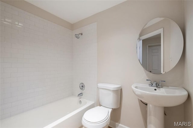 6026 Waterman Blvd Unit 1W, Saint Louis, MO 63112 - bathroom with toilet, tub / shower combination, baseboards, and a sink