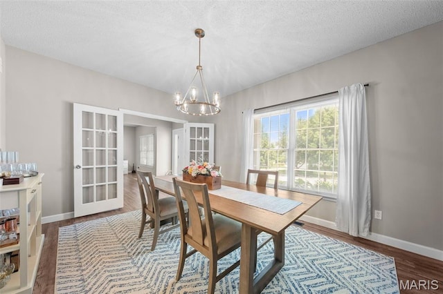 11 Country Crossing Estates Dr, Saint Peters, MO 63376 - dining room with a chandelier, french doors, plenty of natural light, wood finished floors, and a textured ceiling