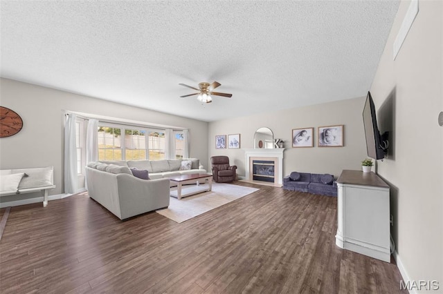 11 Country Crossing Estates Dr, Saint Peters, MO 63376 - living area featuring ceiling fan, dark wood-style floors, a textured ceiling, and a fireplace with flush hearth