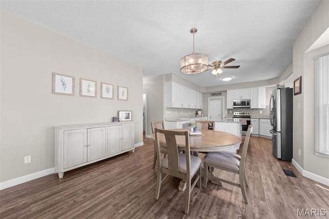 11 Country Crossing Estates Dr, Saint Peters, MO 63376 - dining area featuring dark wood finished floors, a ceiling fan, and a chandelier
