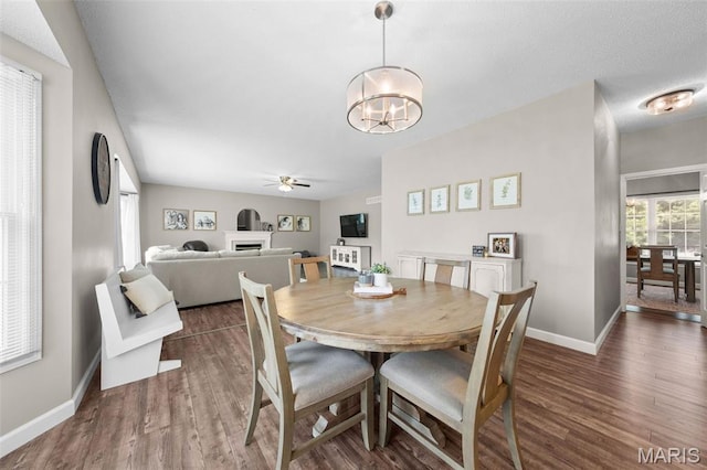 11 Country Crossing Estates Dr, Saint Peters, MO 63376 - dining area featuring a fireplace, a ceiling fan, wood finished floors, and a chandelier