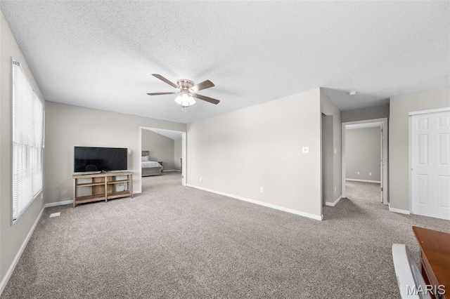 11 Country Crossing Estates Dr, Saint Peters, MO 63376 - unfurnished living room with a ceiling fan, carpet, and a textured ceiling