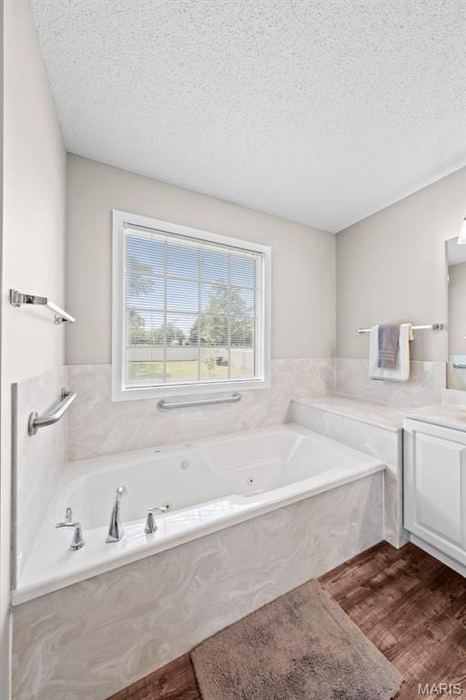 11 Country Crossing Estates Dr, Saint Peters, MO 63376 - full bathroom with vanity, a textured ceiling, a jetted tub, and wood finished floors