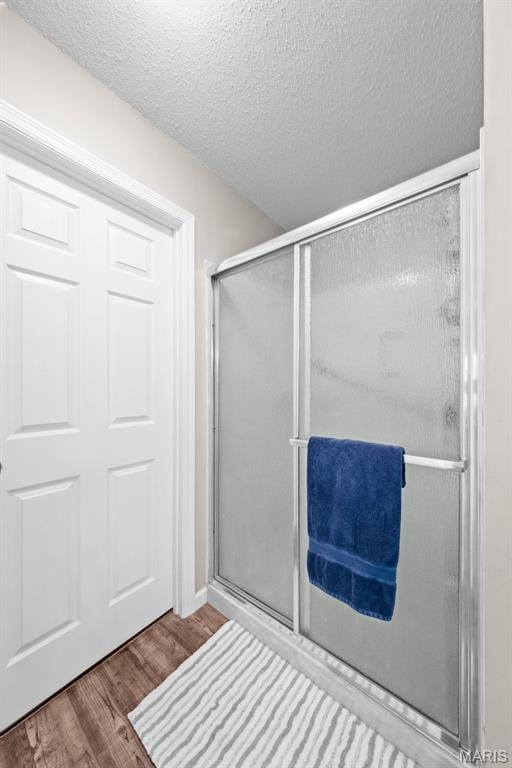 11 Country Crossing Estates Dr, Saint Peters, MO 63376 - full bath with wood finished floors, a shower stall, and a textured ceiling