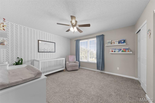 11 Country Crossing Estates Dr, Saint Peters, MO 63376 - bedroom featuring an accent wall, wallpapered walls, a textured ceiling, carpet, and a closet