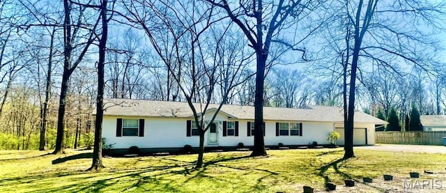 single story home featuring a garage and driveway