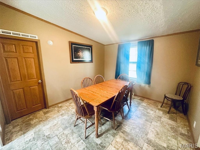 dining room featuring crown molding, a textured ceiling, baseboards, and stone finish flooring