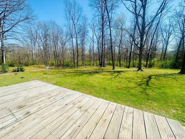 wooden terrace with a yard