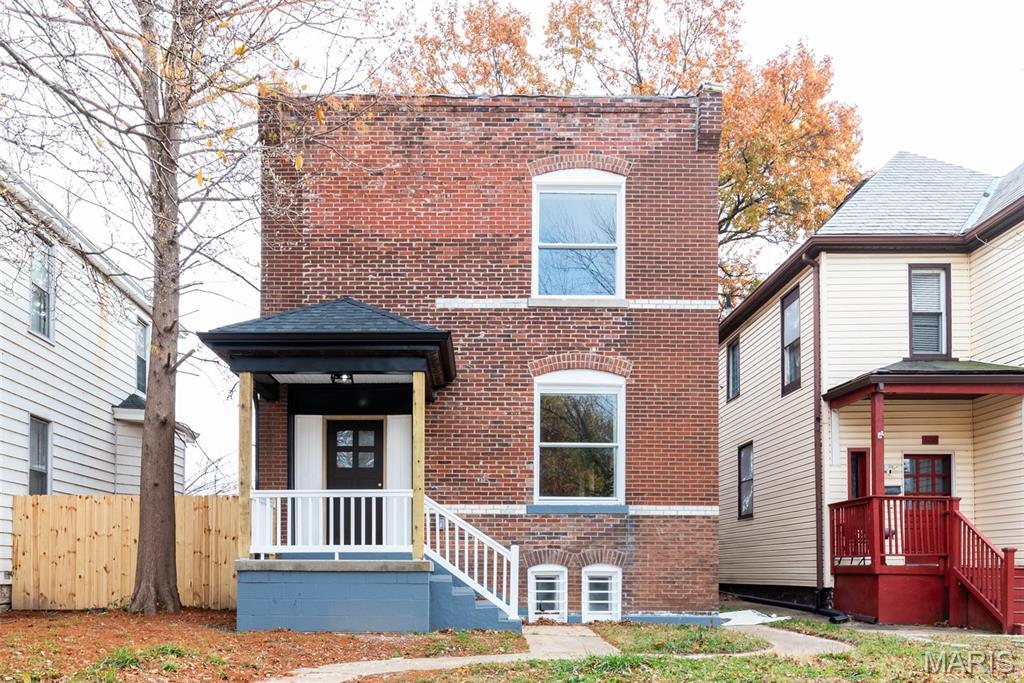 6212 Virginia Ave, Saint Louis, MO 63111 - view of front of home with brick siding and fence
