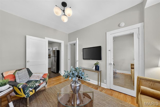 837 Tuxedo Blvd, Saint Louis, MO 63119 - living area with wood finished floors and a chandelier