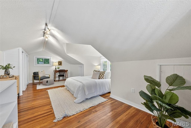 837 Tuxedo Blvd, Saint Louis, MO 63119 - bedroom with vaulted ceiling, hardwood / wood-style flooring, and a textured ceiling