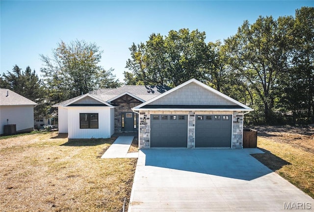 235 Sunny Dr, Rolla, MO 65401 - view of front of property featuring stone siding, a front yard, and concrete driveway