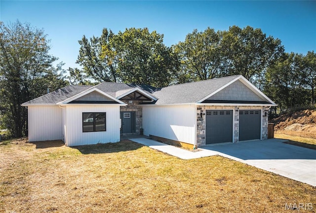 235 Sunny Dr, Rolla, MO 65401 - view of front facade featuring stone siding, an attached garage, concrete driveway, and a front lawn