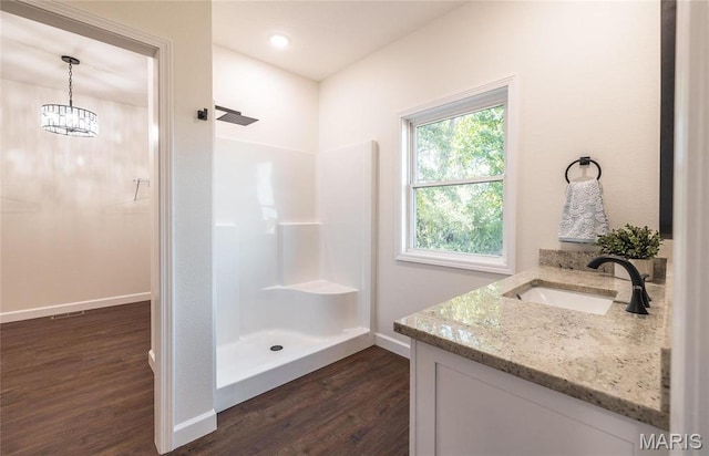 235 Sunny Dr, Rolla, MO 65401 - full bath featuring wood finished floors, walk in shower, baseboards, and vanity
