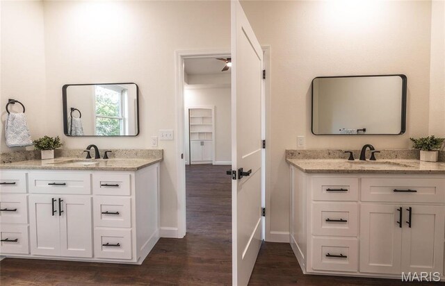 235 Sunny Dr, Rolla, MO 65401 - full bathroom featuring baseboards, two vanities, and wood finished floors