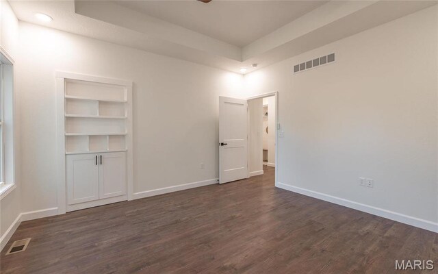 235 Sunny Dr, Rolla, MO 65401 - unfurnished room featuring dark wood finished floors, baseboards, and a raised ceiling