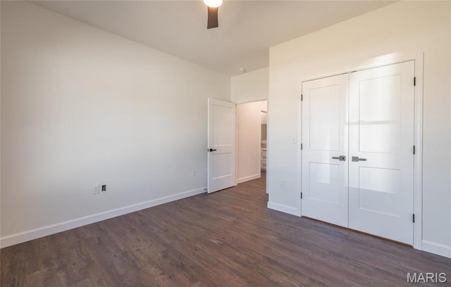 235 Sunny Dr, Rolla, MO 65401 - unfurnished bedroom with dark wood-type flooring, baseboards, a closet, and a ceiling fan