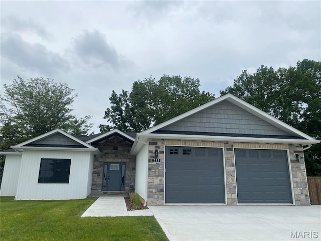 235 Sunny Dr, Rolla, MO 65401 - view of front facade with stone siding, driveway, a front yard, and an attached garage