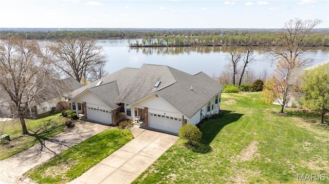 aerial view of property and surrounding area with a nearby body of water