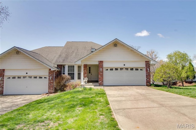 view of front of house with a garage, brick siding, a front lawn, and driveway