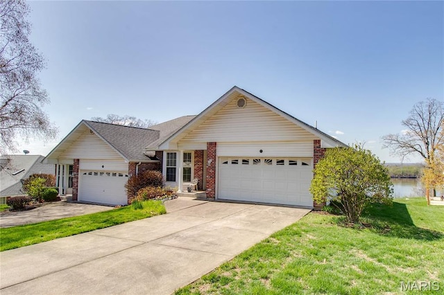 single story home with brick siding, a front yard, an attached garage, and concrete driveway